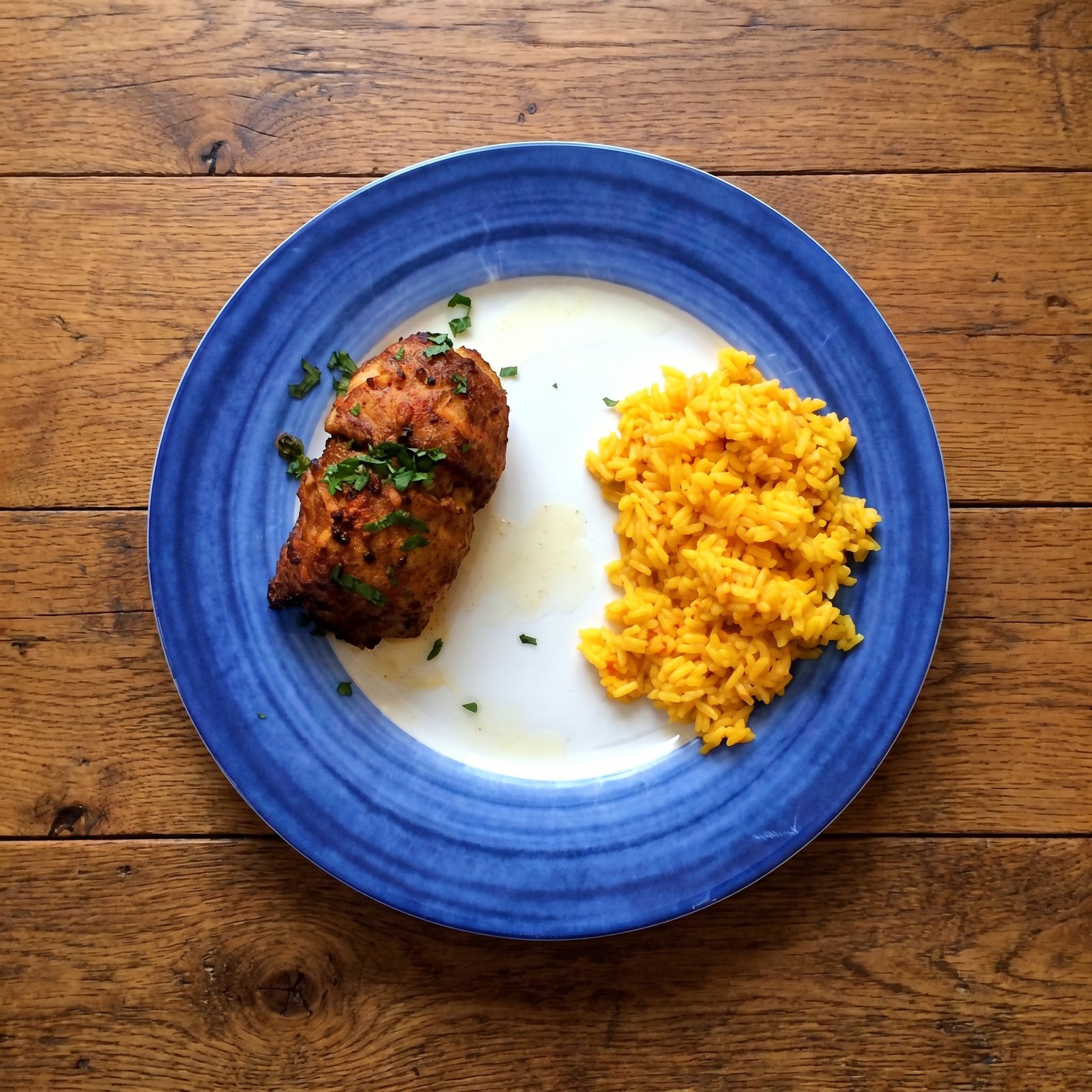 Crab-stuffed flounder with yellow rice on a blue plate
